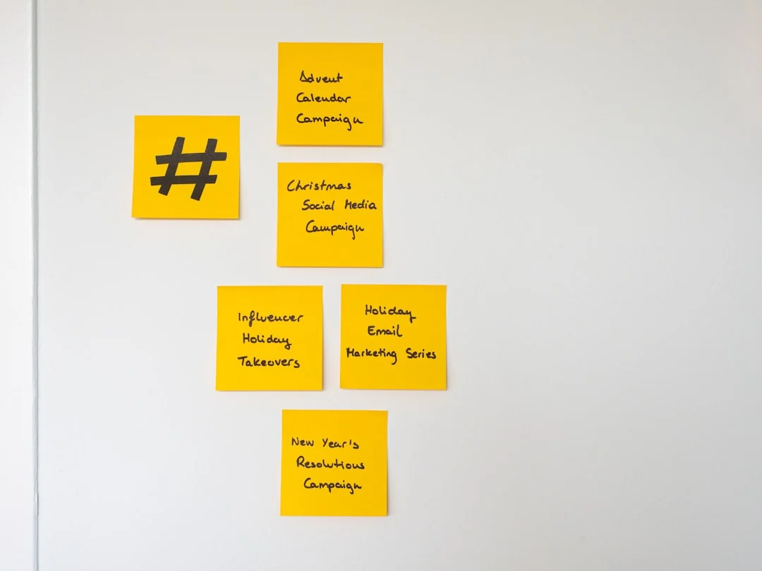 A varied team working together on digital marketing strategies around a desk, with laptops and tablets in use.