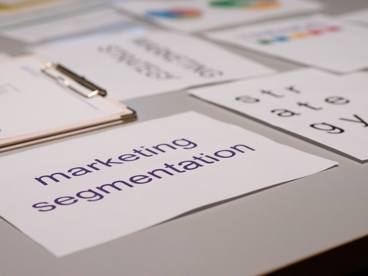 Close-up view of several marketing documents laid out on a desk, ideal for business and strategy conversations.